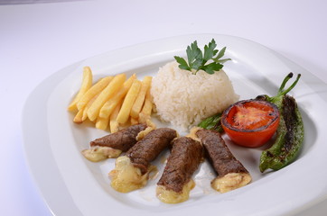 rolled beef steaks filled with cheese with salad and french fries