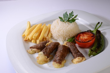 rolled beef steaks filled with cheese with salad and french fries