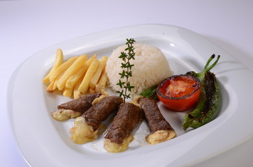rolled beef steaks filled with cheese with salad and french fries