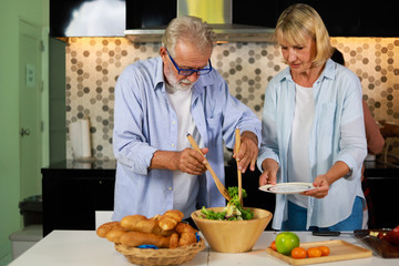 Senior couple Man and woman cooking in kitchen happy mood