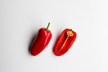Whole and cross section of fresh mini red peppers isolated on white.