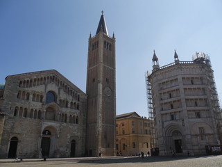 Fototapeta na wymiar Parma Cathedral and Baptistery square. In the square beside the Cathedral lies the octagonal Batipstery. They are religious building built in Medieval age.