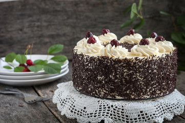 Black forest cake, Schwarzwald pie, dark chocolate and cherry dessert on wooden background