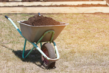 Garden cart with humus and shovel scoop