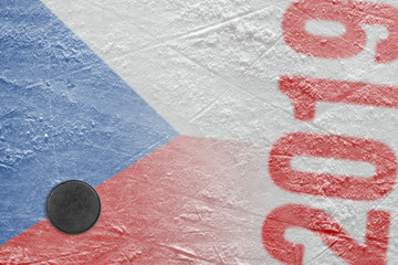 Puck and the image of the Czech flag on the ice hockey arena
