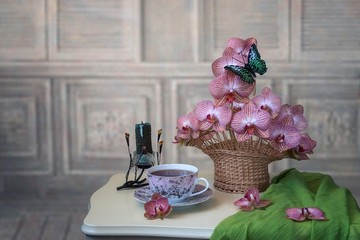Still life with basket of orchid flowers 