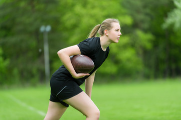 Girl playing rugby together outside in summer