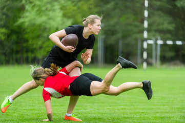 The young female rugby player on green backround
