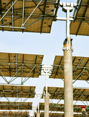 Naklejka premium Looking up at the bottom of the solar photovoltaic panel with automatic rotating bearings