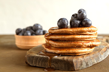 Chocolate pancakes with blueberries on a dark background.