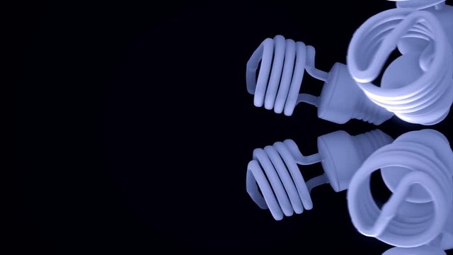 Close up for blue energy saving lamps rotating isolated on black background. Animation. Abstract motion of shining halogen bulbs, seamless loop.