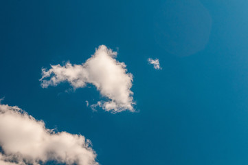 fluffy white cloud on air clear blue sky weather background. high contrast
