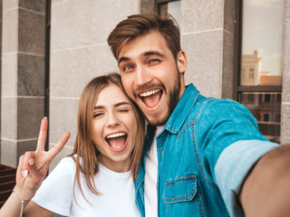 Smiling beautiful girl and her handsome boyfriend in casual summer clothes. Happy family taking...