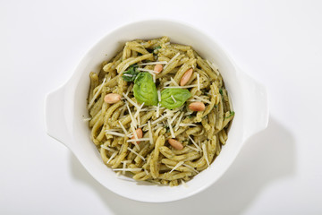 healthy basil sauce pasta top view isolated in a plate