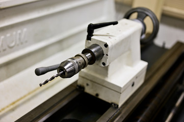 Drill attachment in lathe head.