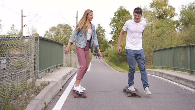 Couple skateboarding together on their longboards