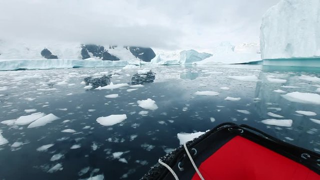 cruise in Antarctica, small inflatable boat travel through the ice in Iceberg Graveyard, beautiful nature landscape