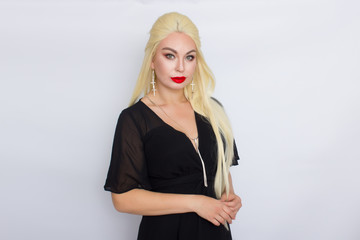 Blonde woman with brigh makeup wearing black evening dress