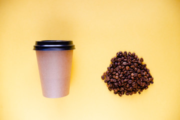 Roasted coffee grains and takeaway cup top view. Craft paper tea cup on orange background flat lay. Cafe web banner with copyspace