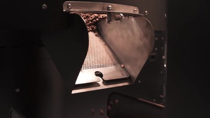 Slowmotion of coffee roasting machine transporting coffee beans