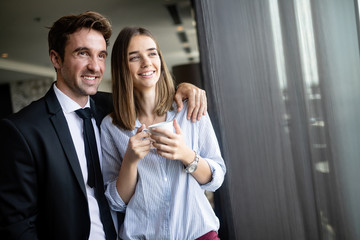 Handsome man and attractive woman are spending time together. Taking coffee break and communicating.