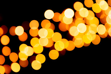 Defocused city gold night bokeh abstract background. blurred many round yellow light on dark background