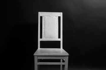 Naklejka premium White chair on the black background