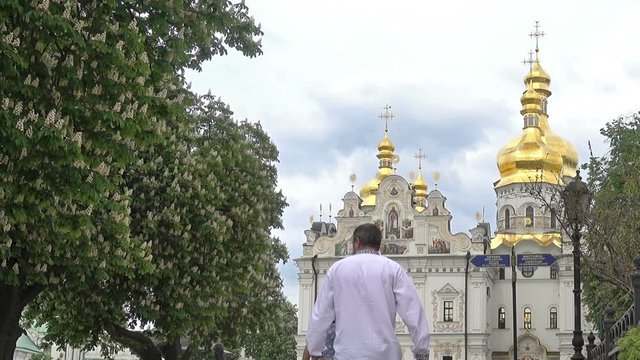 People walking to the Assumption Cathedral of Kiev-Pechersk Lavra on a spring day