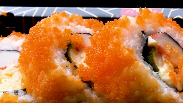California rolls in plastic takeaway box from convenience store, closed up.
