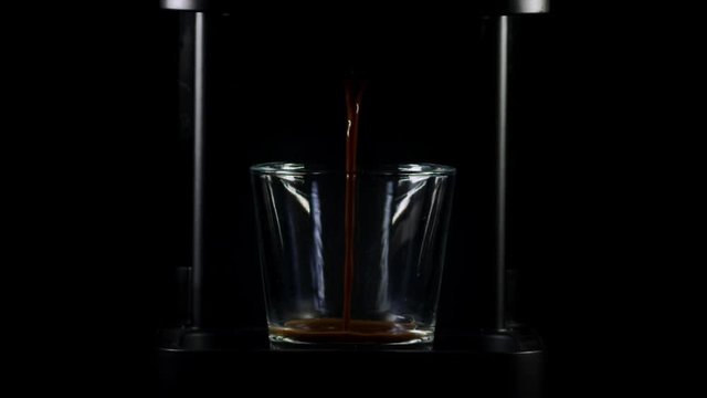 Slowmotion &ndash; Espresso machine doing amazing coffee with cream in a simetric small cup with professional studio lightning