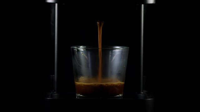 RED camera : Espresso machine doing amazing coffee with cream in a simetric small cup with professional studio lightning