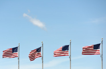 American flags waving on the blue sky