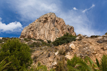 Fototapeta na wymiar Calp Costa Blanca Spain view up to Penon de Ilfach the large rock from the walk around the bottom of the famous landmark