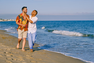 a gay interracial couple at the beach