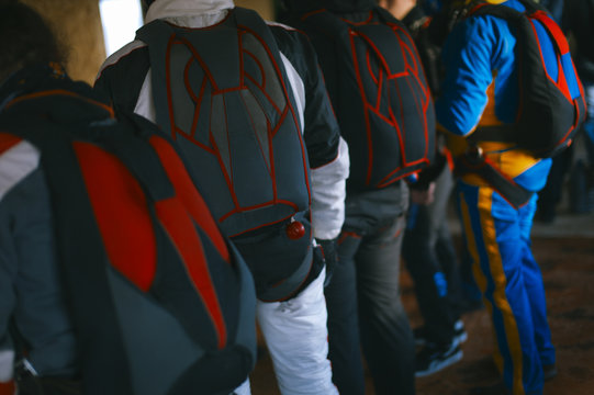 Parachute Knapsacks On The Backs Of Skydivers Close-up, Rear View. Parachute Equipment.