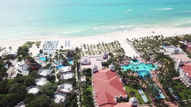 Top view of beautiful beach. Aerial drone shot of turquoise sea water at the beach. Luxury tropical resort with white sand. Aerial view