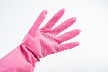 Wearing pink rubber gloves in one hand on white background