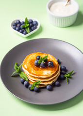 Stack of home made pancakes served with fresh berries and maple syrup. Simple and delicious breakfast