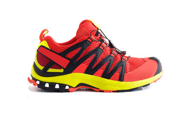 Side view of red trail running shoe or trekking boot isolated on white background