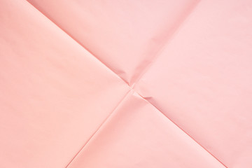 Pink coral wrapping paper background with crease texture. Geometry abstract art concept backdrop.