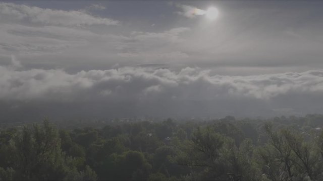 Time-lapse of rolling hills and clouds during sunrise