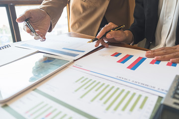 Business team brainstorming and discussing with financial data and report graph. Teamwork meeting working concept.