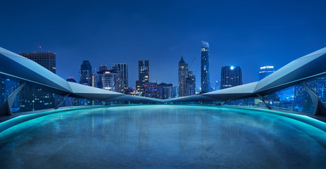Panoramic view of futuristic geometric shapes design empty floor with Bangkok city skyline . Night...