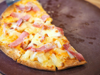 Delicious pizza served on wooden plate