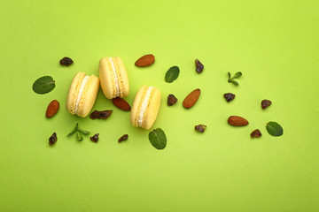 Tasty macarons on color background