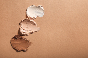 Different tonal foundations on color background