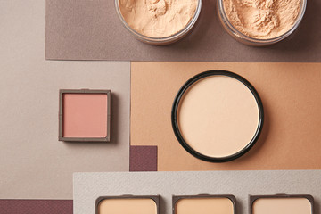 Fototapeta premium Different facial powder on color background