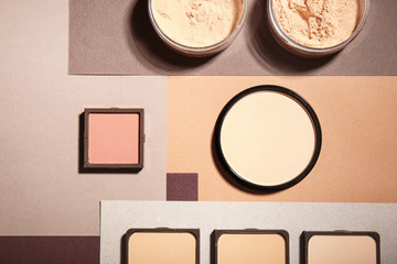 Different facial powder on color background