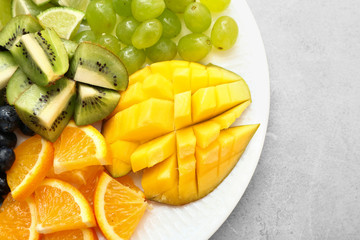 Tasty mango with fresh fruits on plate
