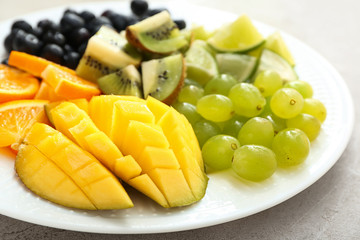 Tasty mango with fresh fruits on plate